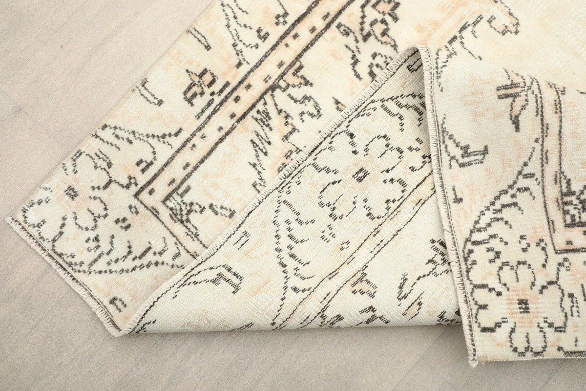 View of the rug folded to show the flexibility and the reverse side of the hand-knotted construction