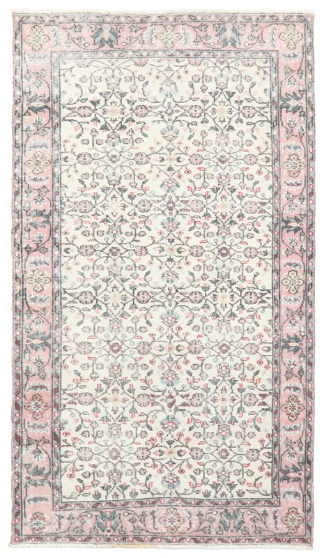 Full top view of the 3'9" x 6'9" vintage Anatolian rug with an ivory field and rose floral patterns