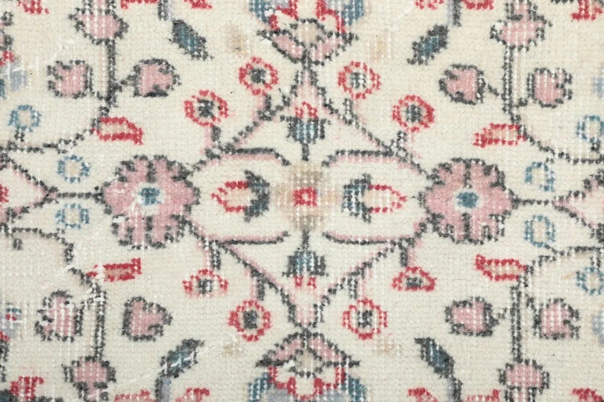 Close-up of the low wool pile showing the intricate knotting and color variations