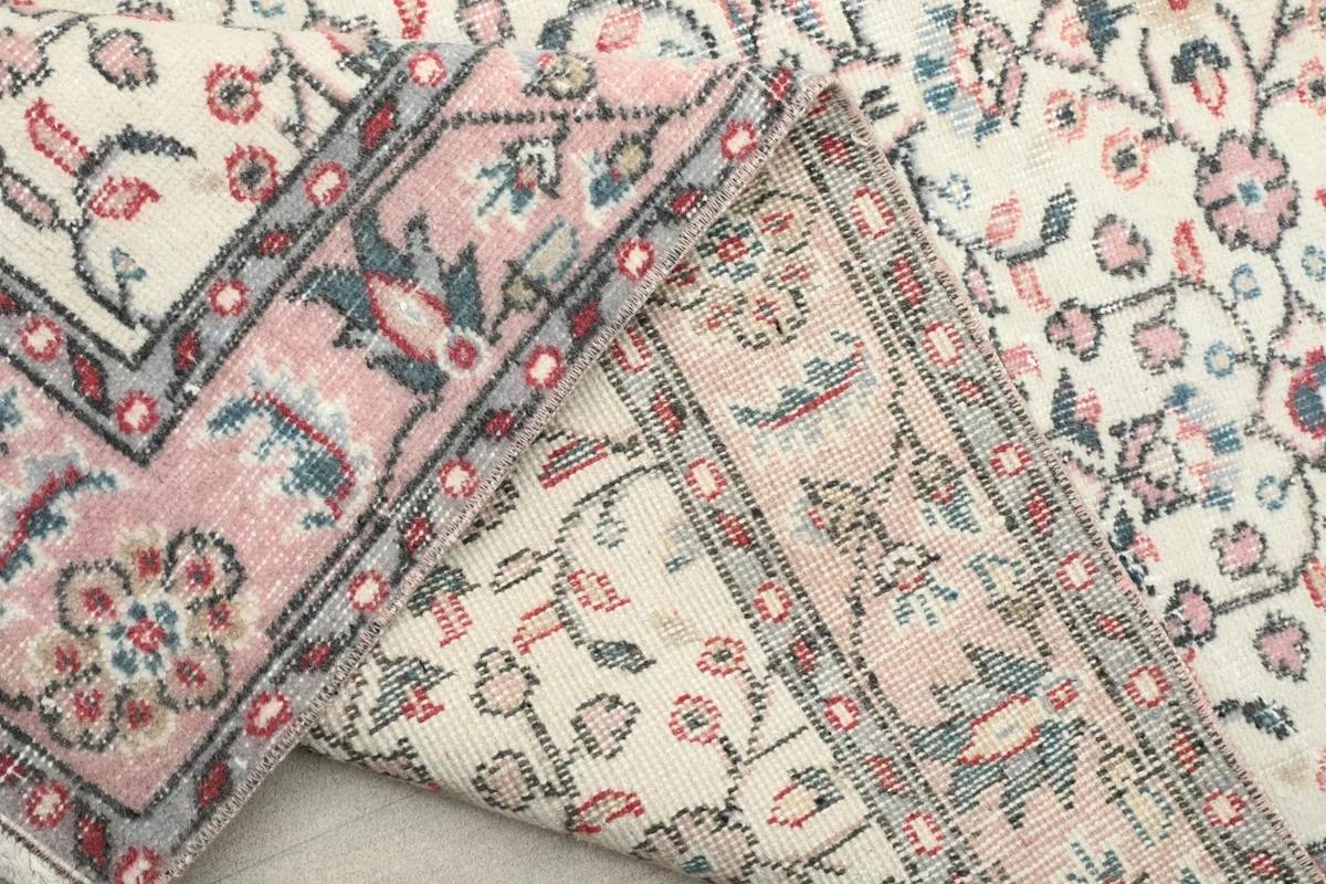 Detailed view of the rug's backing, revealing the tight weave and foundation material
