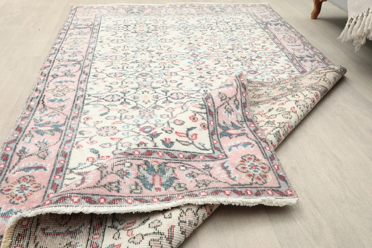 The vintage rug folded to display the thickness and flexibility of the wool pile