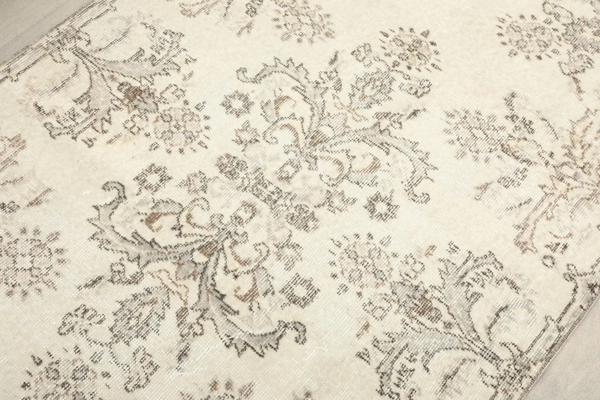 Detailed view of the central floral and geometric motifs with visible wear