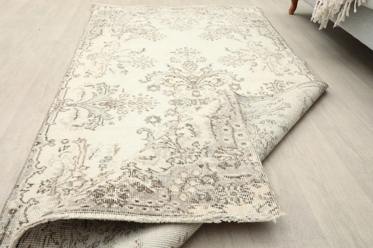 Close-up of the low wool pile and faded texture of the vintage rug