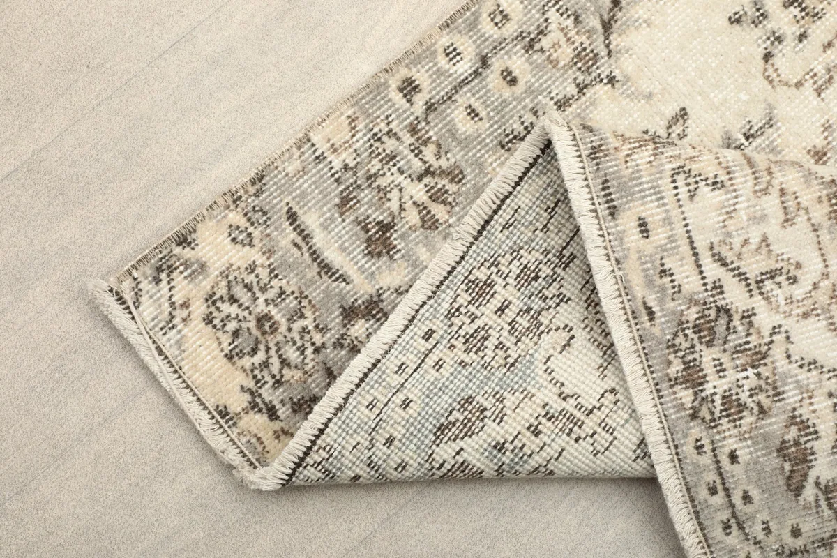 View of the reverse side of the hand-knotted rug showing the cotton foundation