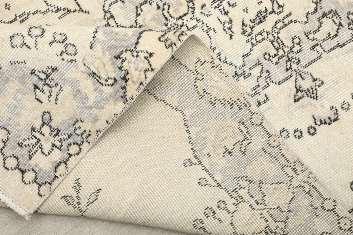 Another folded view, showing the reverse side of the rug and the tight weave of the cotton foundation.