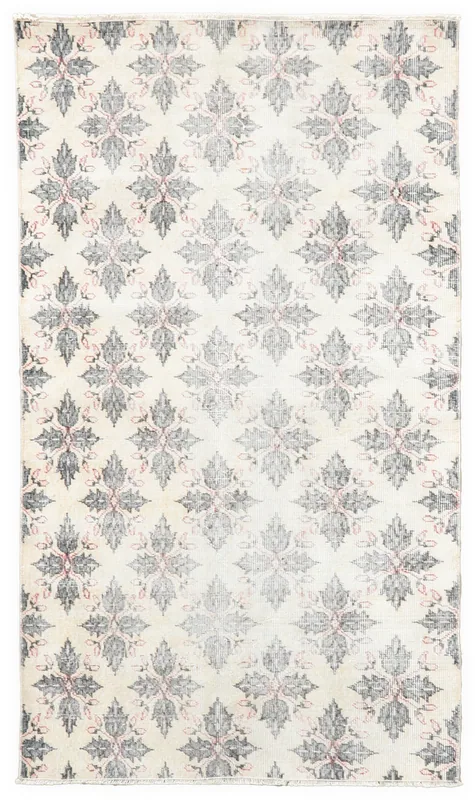 Full overhead view of the ivory, gray, and pink floral grid vintage Anatolian rug