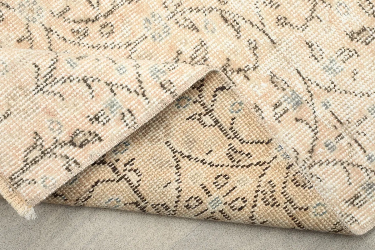 Another view of the folded corner, emphasizing the hand-knotted construction and foundation.