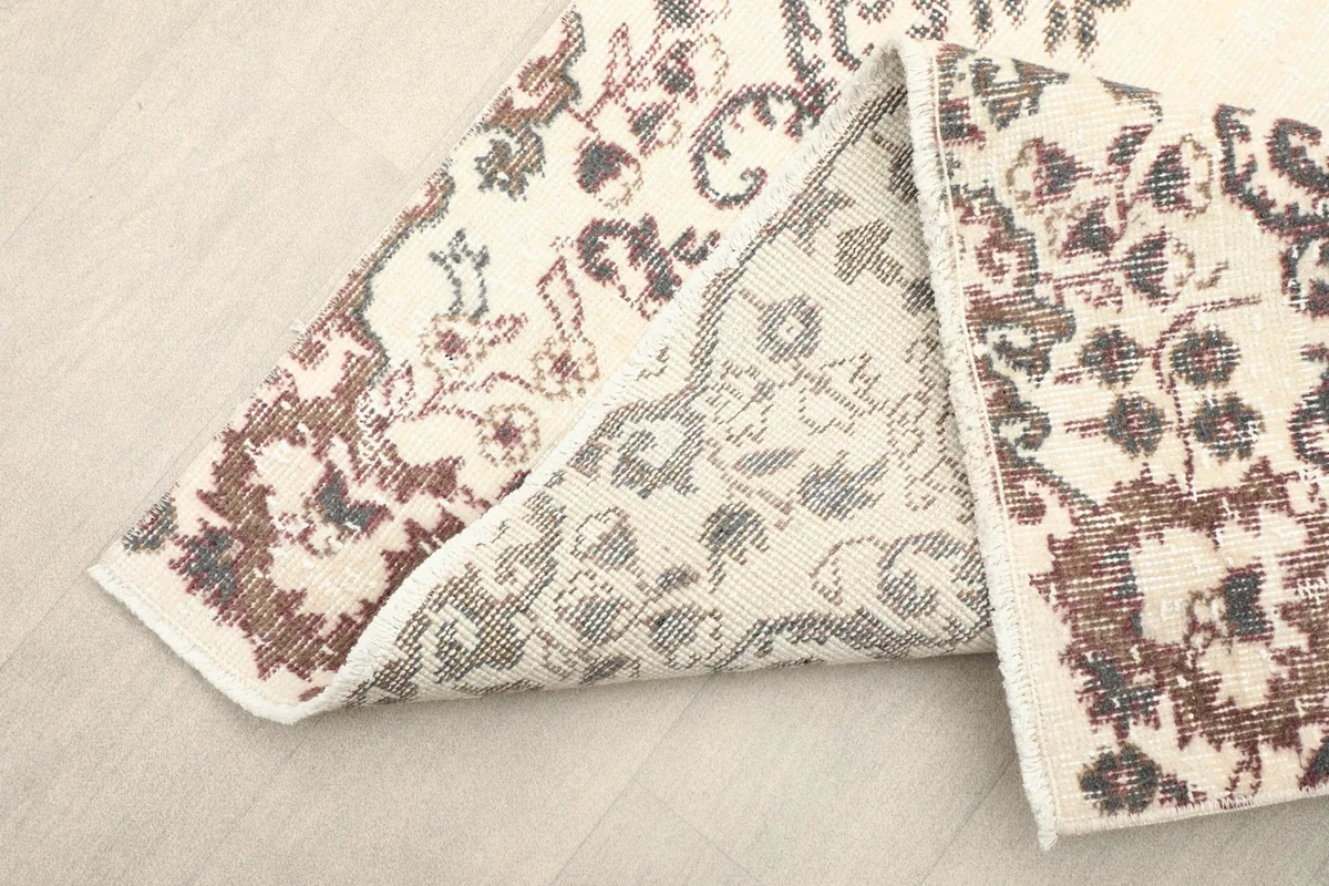 Underside of the rug revealing the cotton foundation and hand-knotted construction