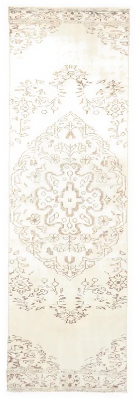 Full overhead view of the ivory and beige Anatolian runner rug with brown medallion and floral patterns
