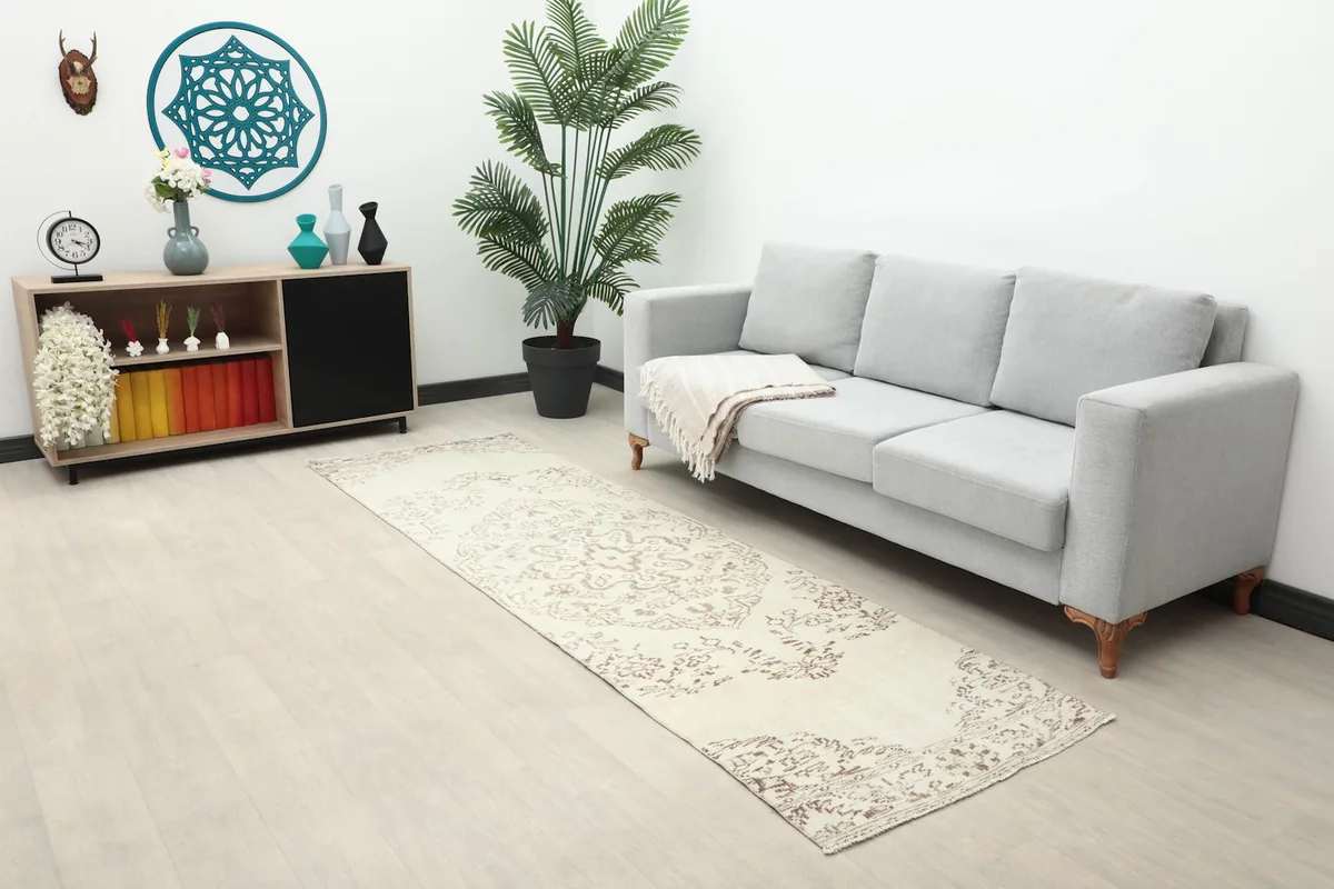 Long shot of the runner rug in a room with a sofa and console, highlighting its fit in a narrow space