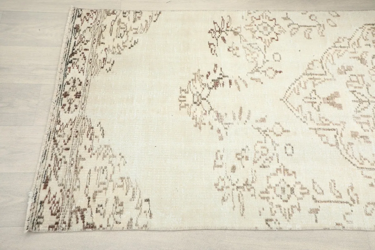 Detailed view of the rug's side and corner, showing the subtle color variations and hand-knotted texture