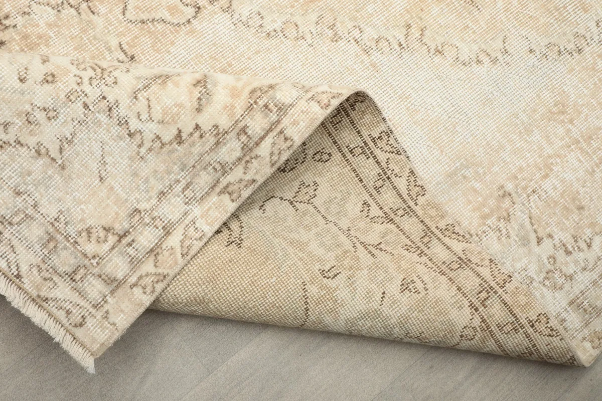 View of the underside of the hand-knotted rug showing its cotton foundation