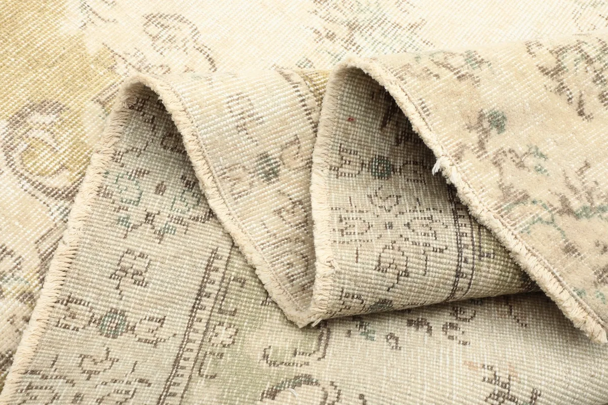 Multiple folds of the rug, demonstrating its flexibility and the texture of the wool pile.