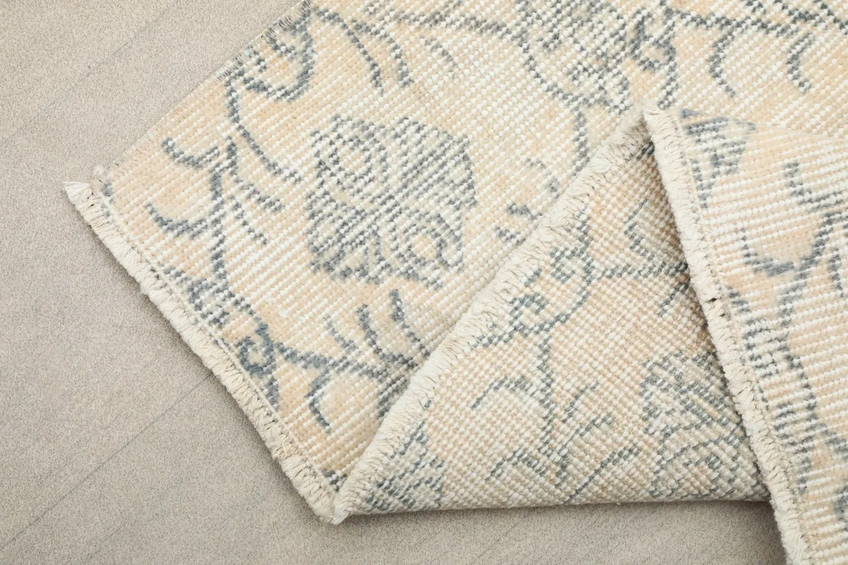Corner of the runner folded to show the hand-knotted construction and the even, low pile.