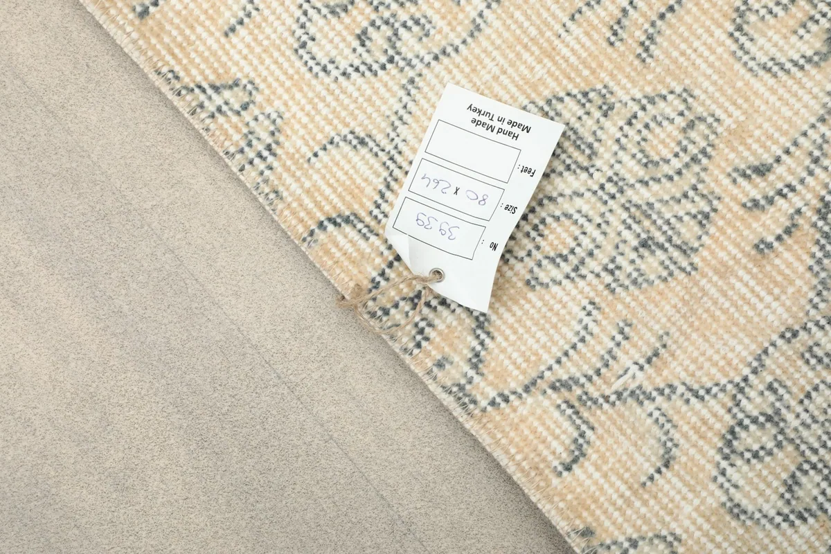 Close-up of the rug's label, indicating its origin from Turkey and unique product details.