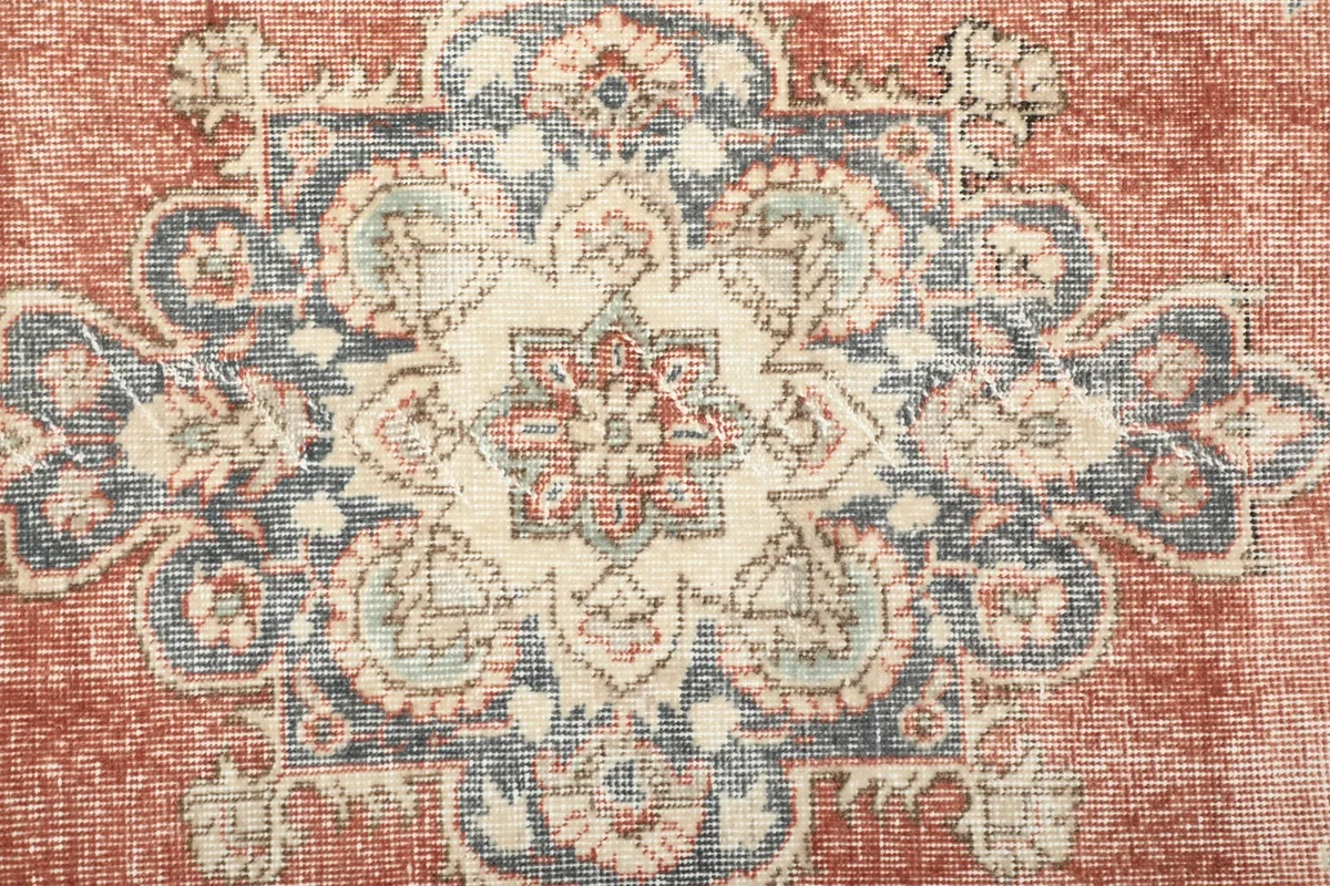 Detailed shot of the central medallion showing the hand-knotted texture and colors