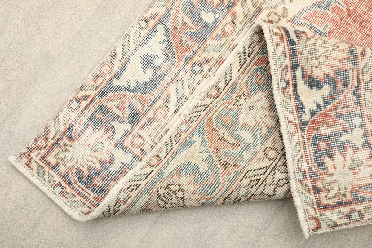 View of the back of the hand-knotted rug, revealing the cotton foundation and knotting