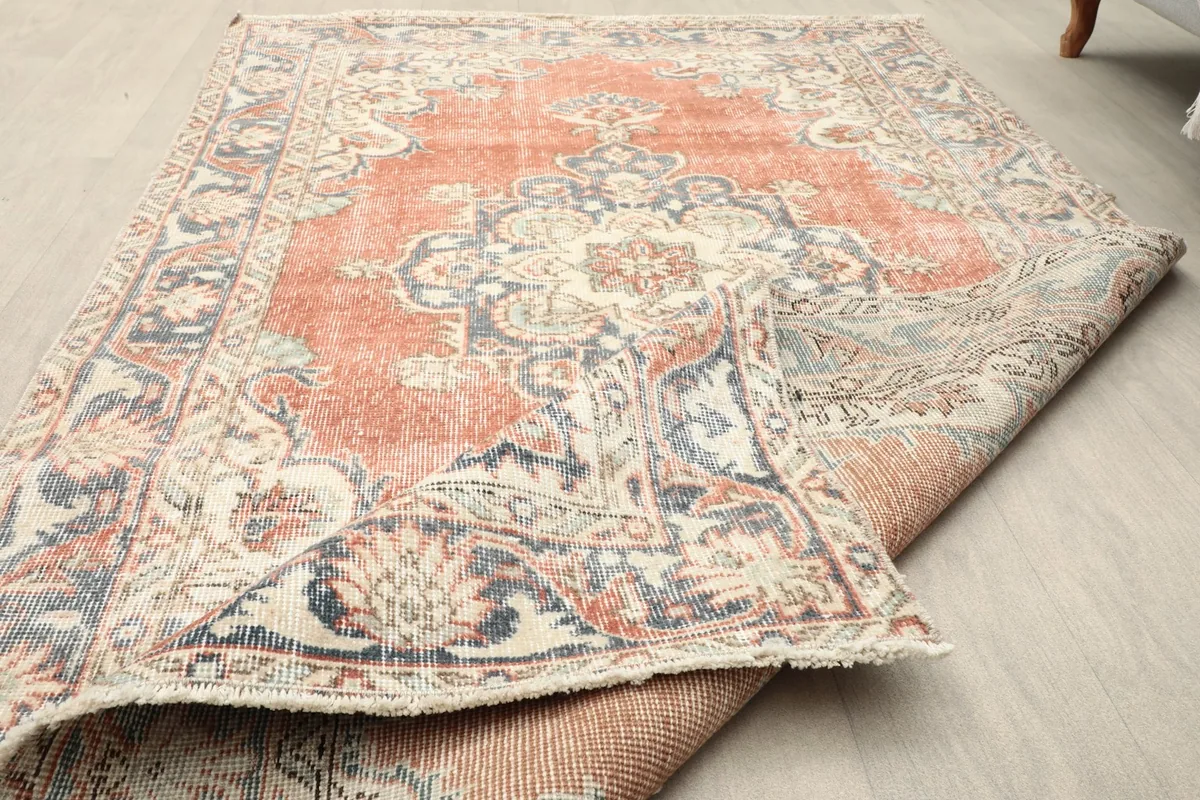 Corner of the rug folded back, showing the back and the low pile texture