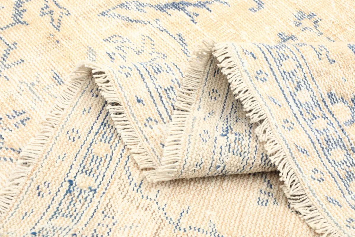 Close-up of the rug's back, showcasing the tightly woven cotton foundation and hand-knotted wool
