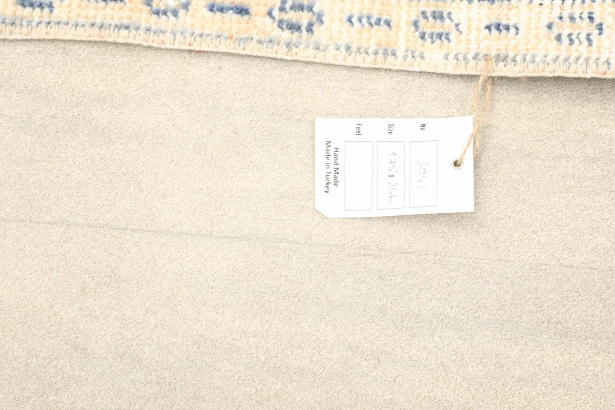 Image showing the product tag with size and origin details attached to the rug