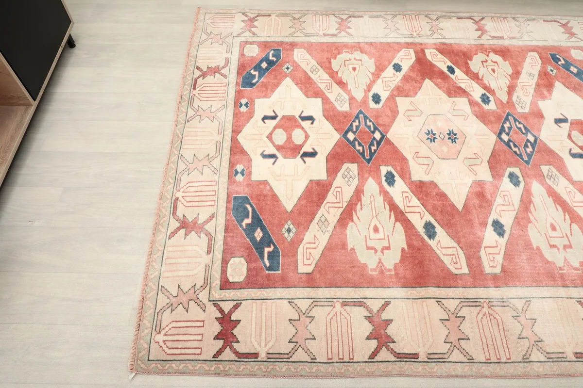 Angled shot of the rug's design and edge, showing its placement near furniture