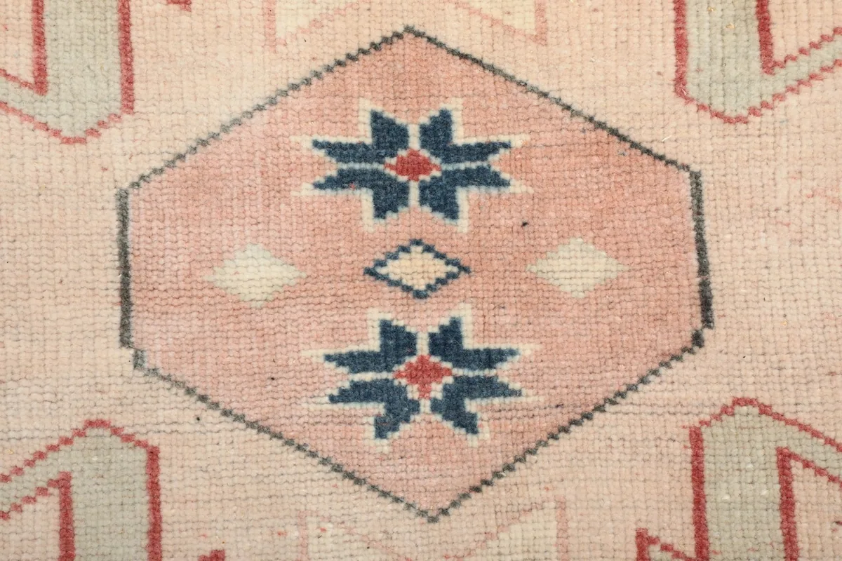 Macro shot of a specific tribal motif, showing the pink and blue star-like elements