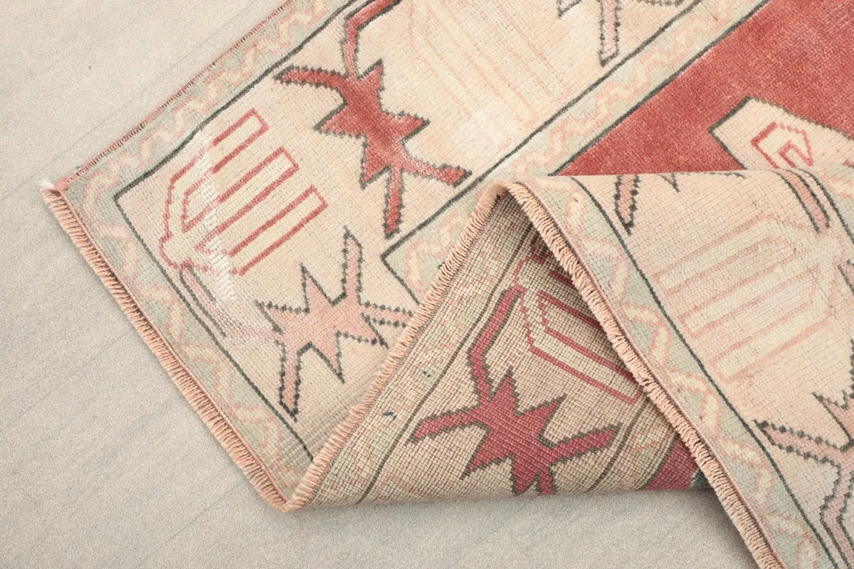 Close-up of the rug's folded edge, showing the texture and fringe
