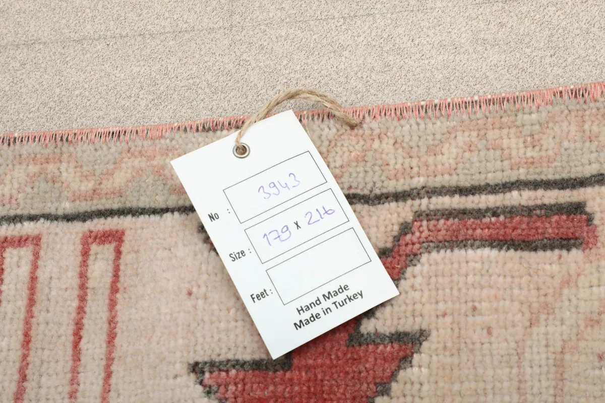 Product tag on the rug showing its size and origin, 'Hand Made in Turkey'