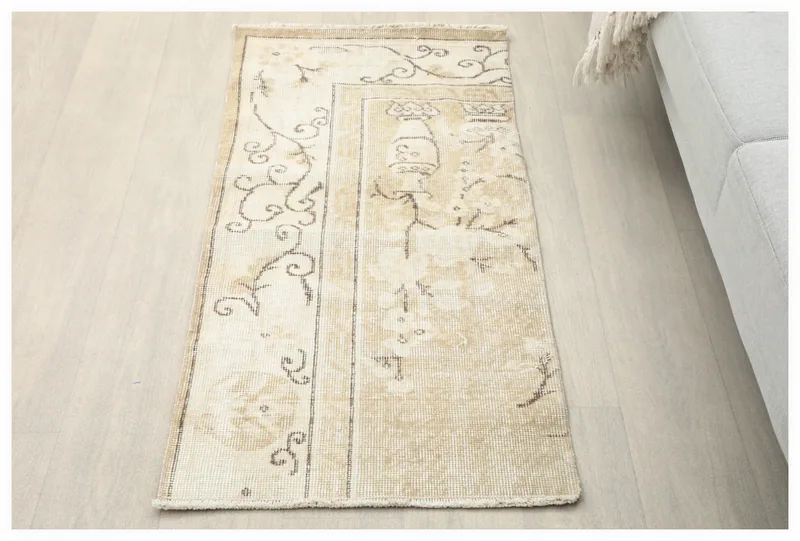 Full top view of the beige and brown vintage Anatolian area rug on a white background.