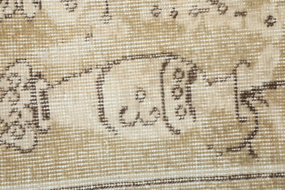 Detailed view of the low wool pile and the intricate hand-knotted texture of the rug.