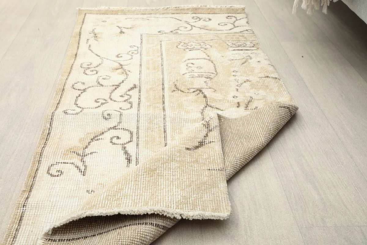 The rug partially folded, demonstrating its flexibility and construction.