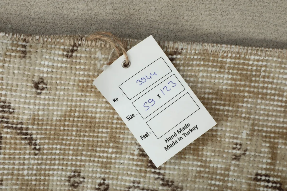 Close-up of the rug's tag, indicating its size and origin as hand-made in Turkey.