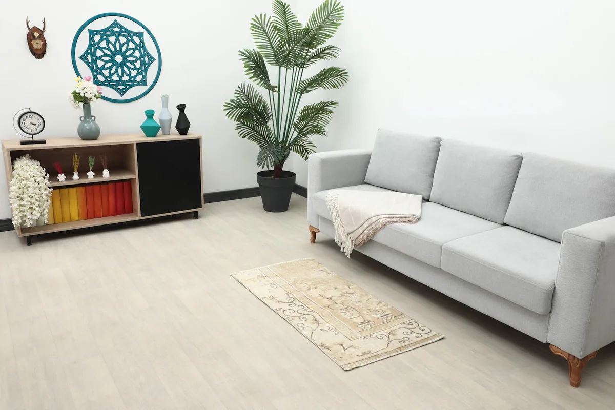 2'0" x 4'0" vintage Anatolian rug displayed in a living room setting with a light gray sofa