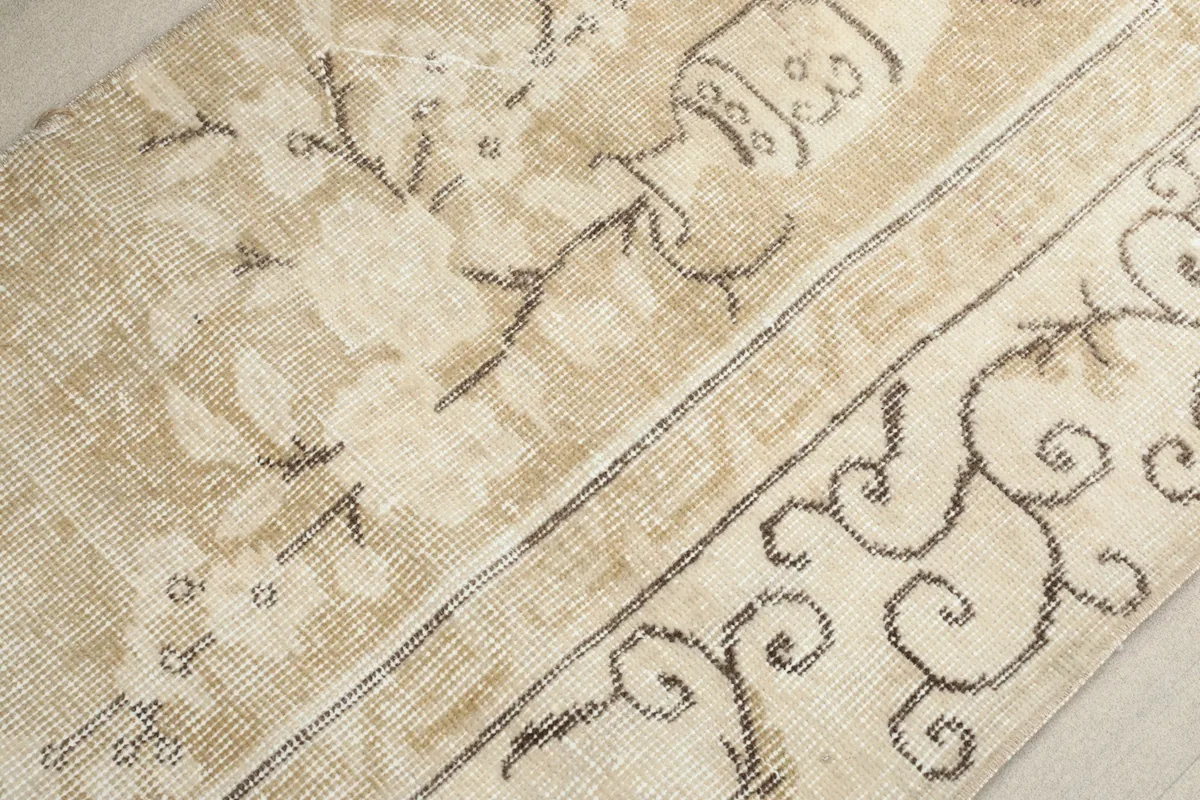 Texture shot of the rug's low pile, revealing the hand-knotted wool and subtle color variations
