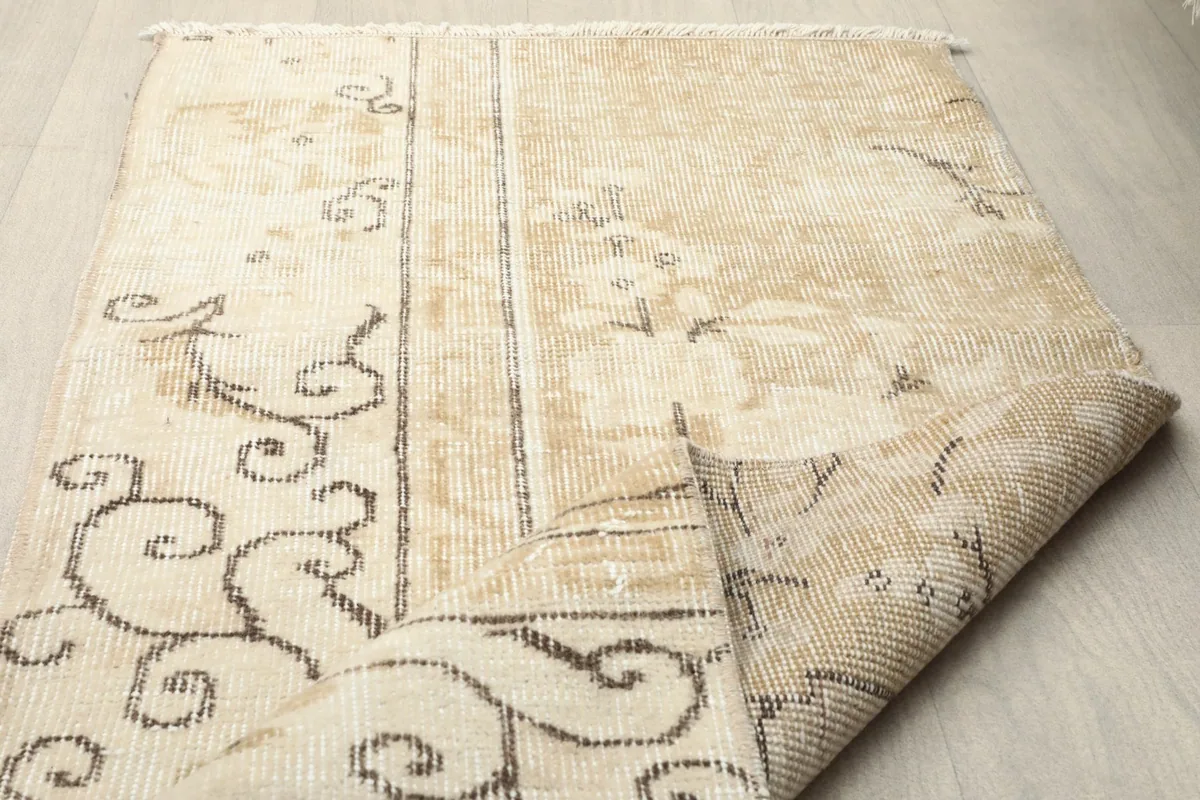Another view of the folded rug, highlighting the construction and vintage character