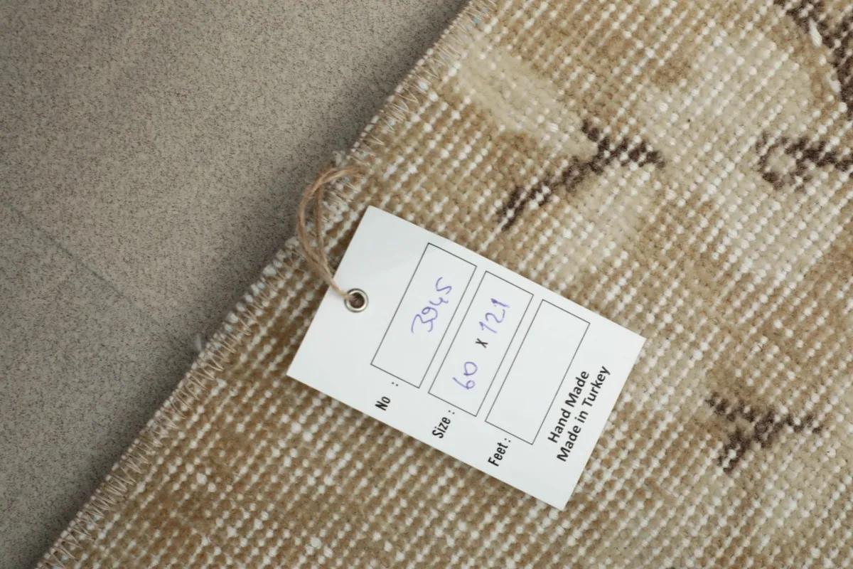Product tag attached to the rug, showing the size in centimeters and stating 'Hand Made in Turkey'