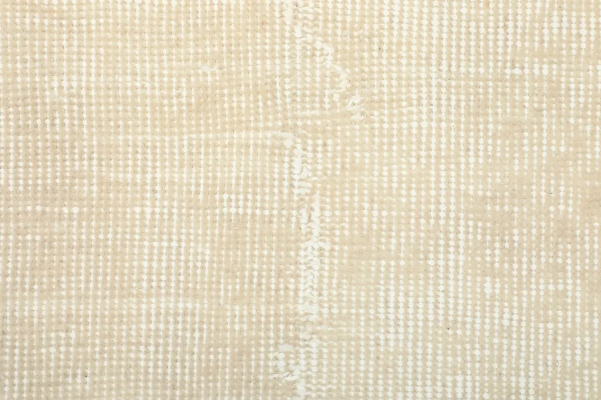 Close-up of the rug's reverse side, revealing the cotton foundation and hand-knotting
