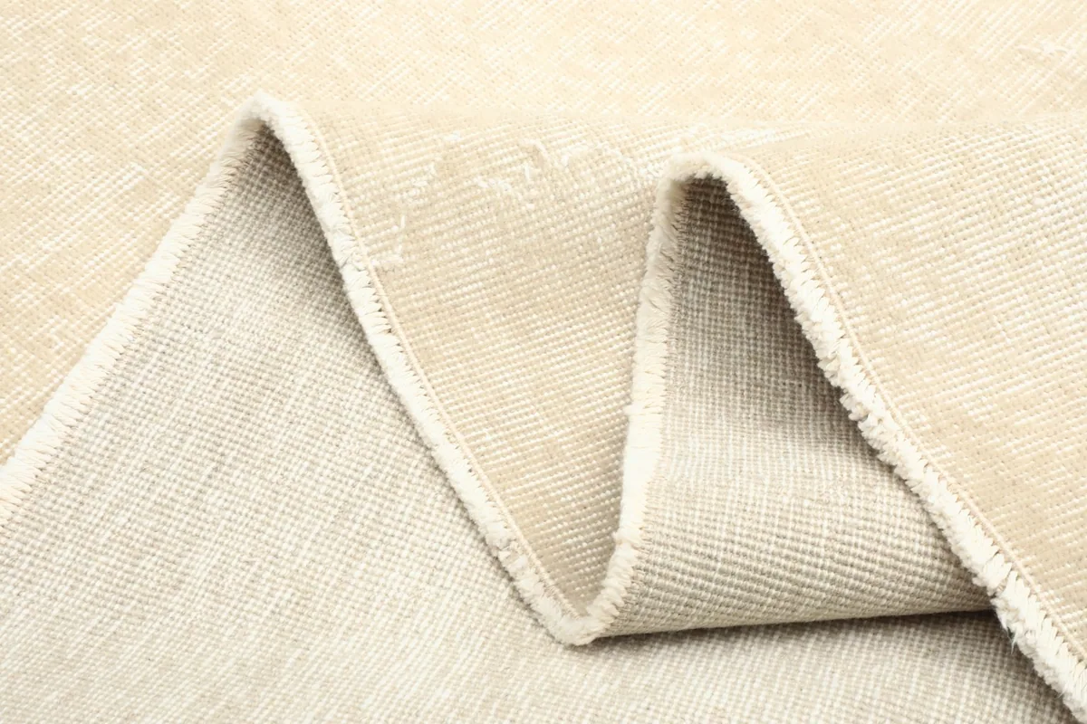 Close-up of the rug folded, highlighting its thickness and material layers