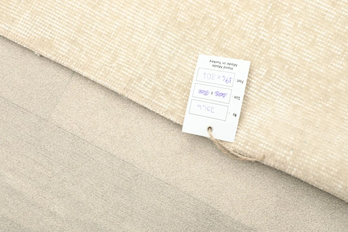 Rug corner with a product tag, showing details and origin