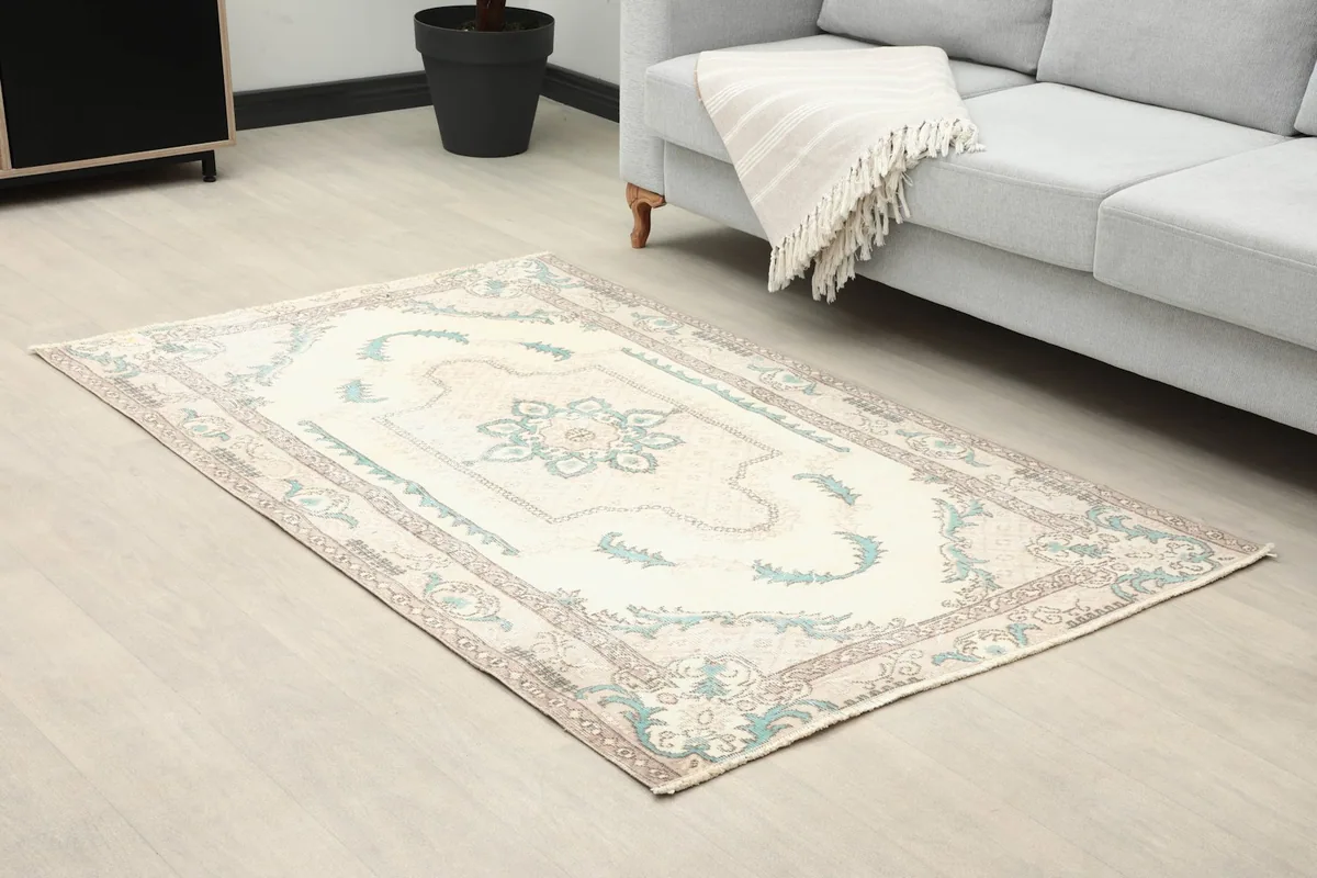 Angle view of the rug in a room, showing its placement in front of a sofa.