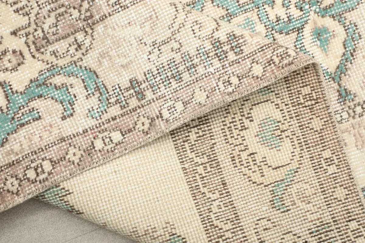 View of the rug's reverse side, revealing the hand-knotted cotton foundation.
