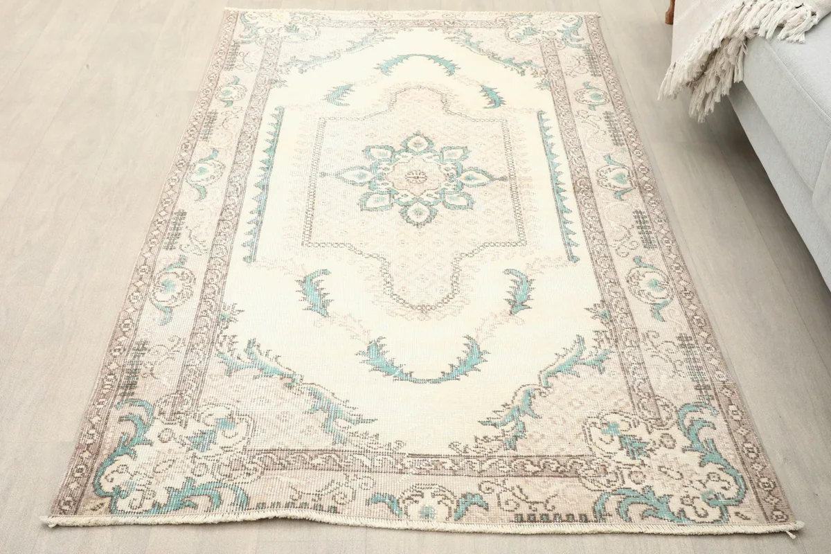 Overhead view of the small area rug on a light floor, showing its full design.
