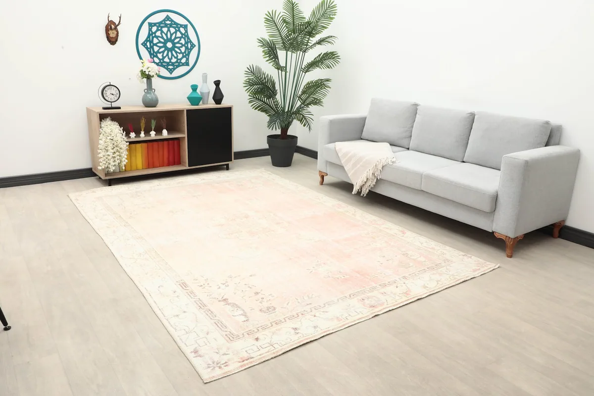 Anatolian rug placed in a spacious room, showing its scale next to a sofa and side cabinet.
