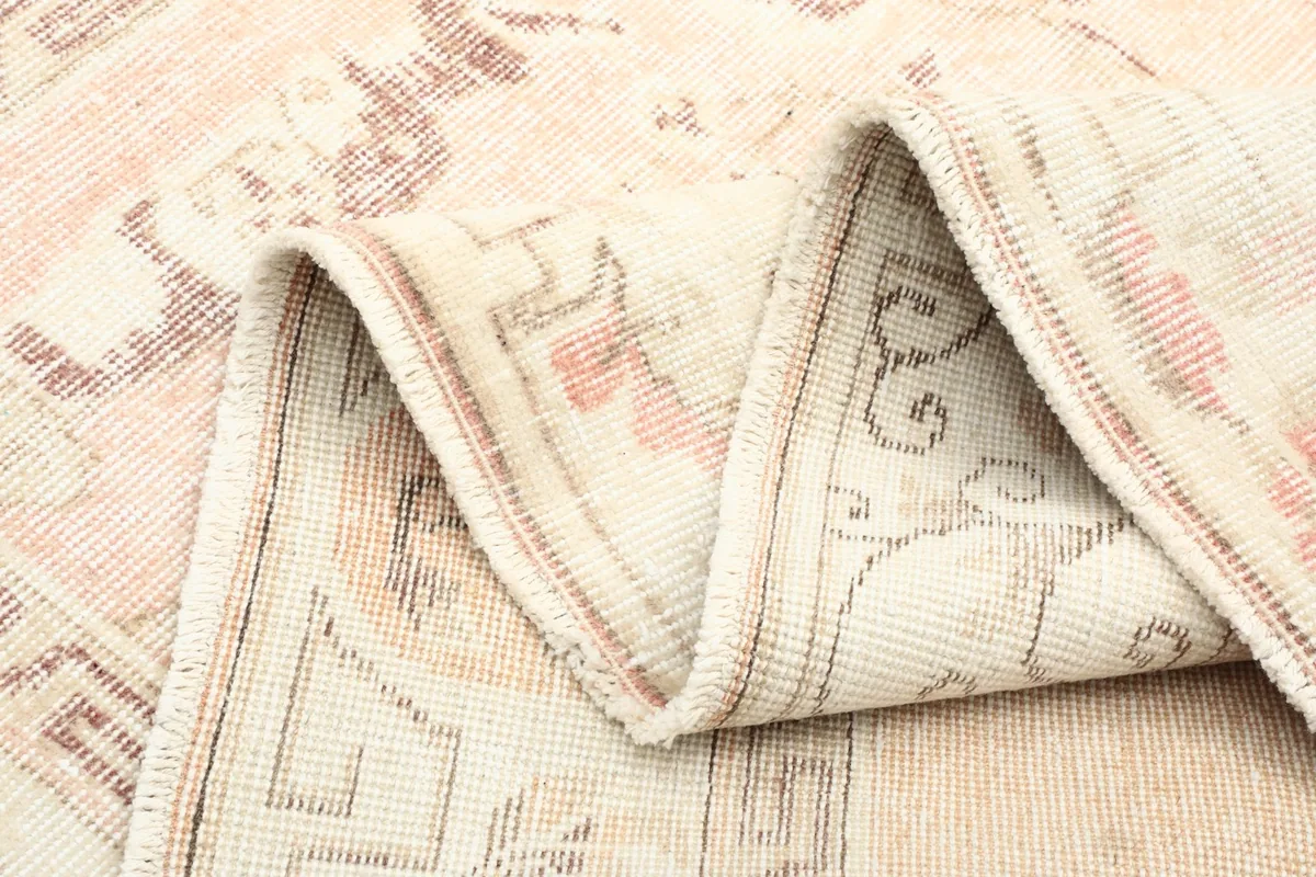 Folded rug showing the flexibility and thickness of the hand-knotted wool and cotton foundation.