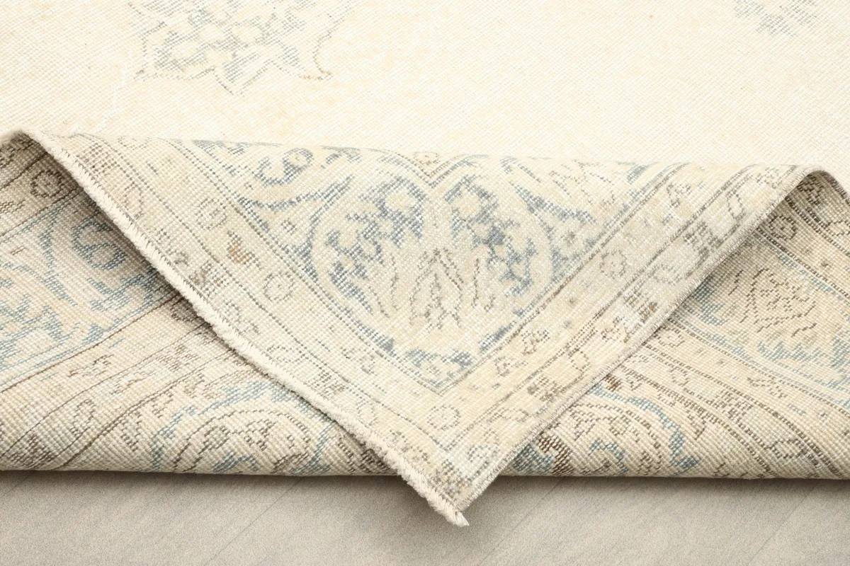 View of the back of the hand-knotted wool rug, showing the cotton foundation and knotting