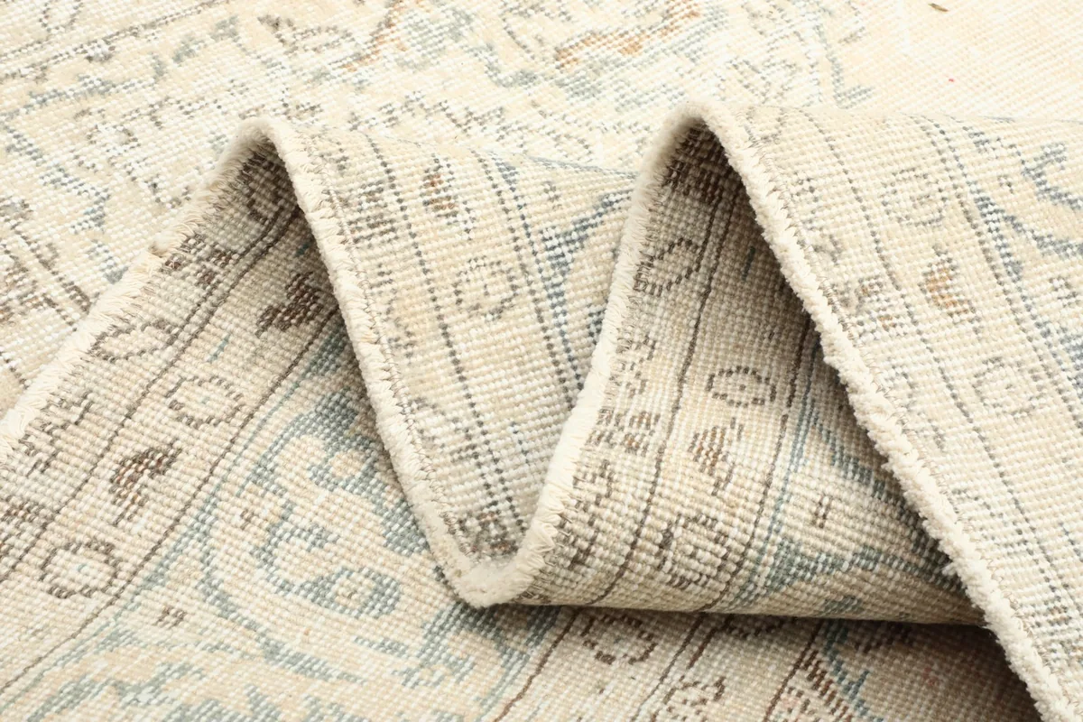 Folded section of the rug, illustrating the flexibility and thickness of the hand-knotted material