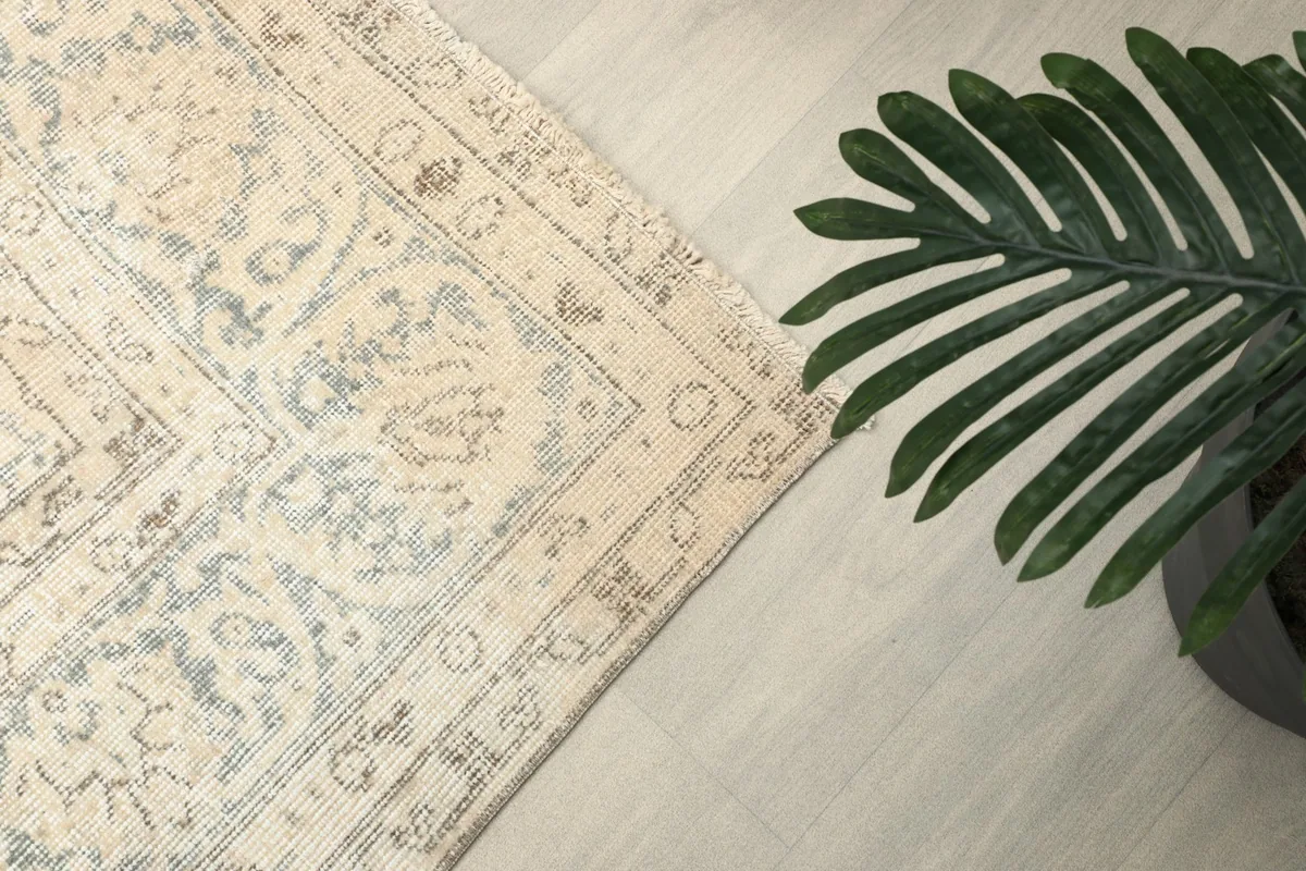 Overhead shot of a rug corner and border, showing the subtle color variations and patterns