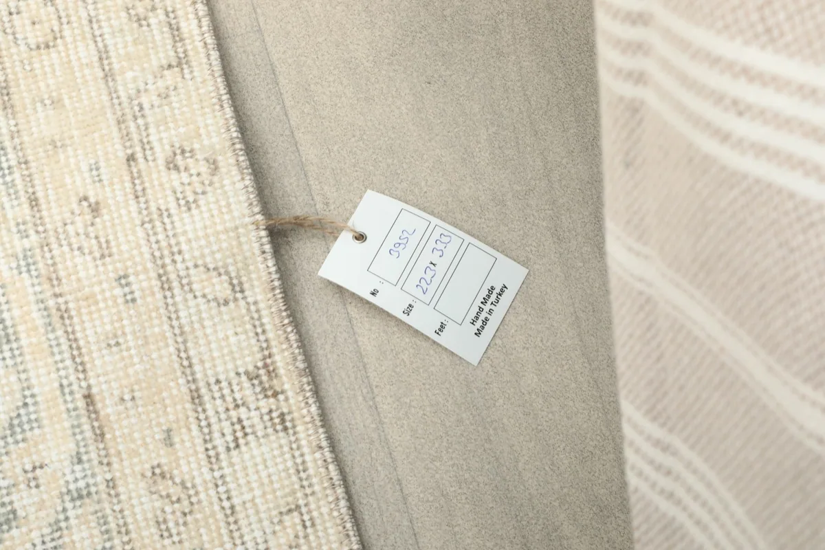 Close-up of the rug's label displaying its size and origin, next to the rug