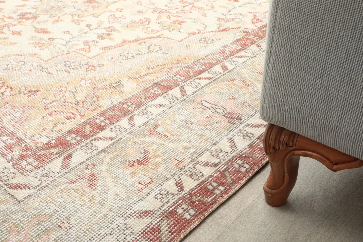 Partial view of the rug next to a sofa leg, showing how it complements home decor