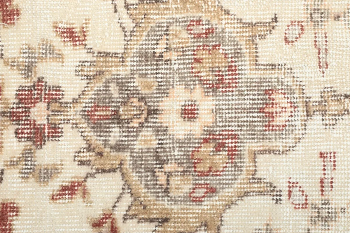 Detailed view of the low wool pile, showing the hand-knotted texture and faded colors